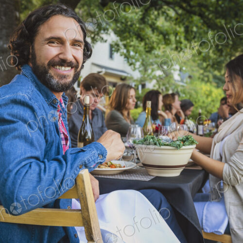 Portrait of smiling man at party outdoors