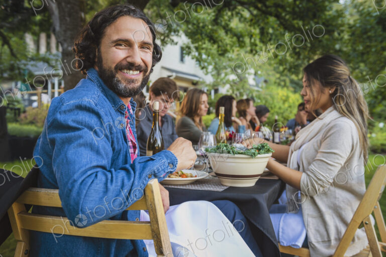 Portrait of smiling man at party outdoors