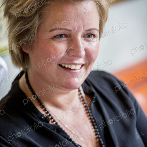 Portrait of smiling woman with short blond hair wearing black top. Portrait of smiling woman with short blond hair wearing black top.