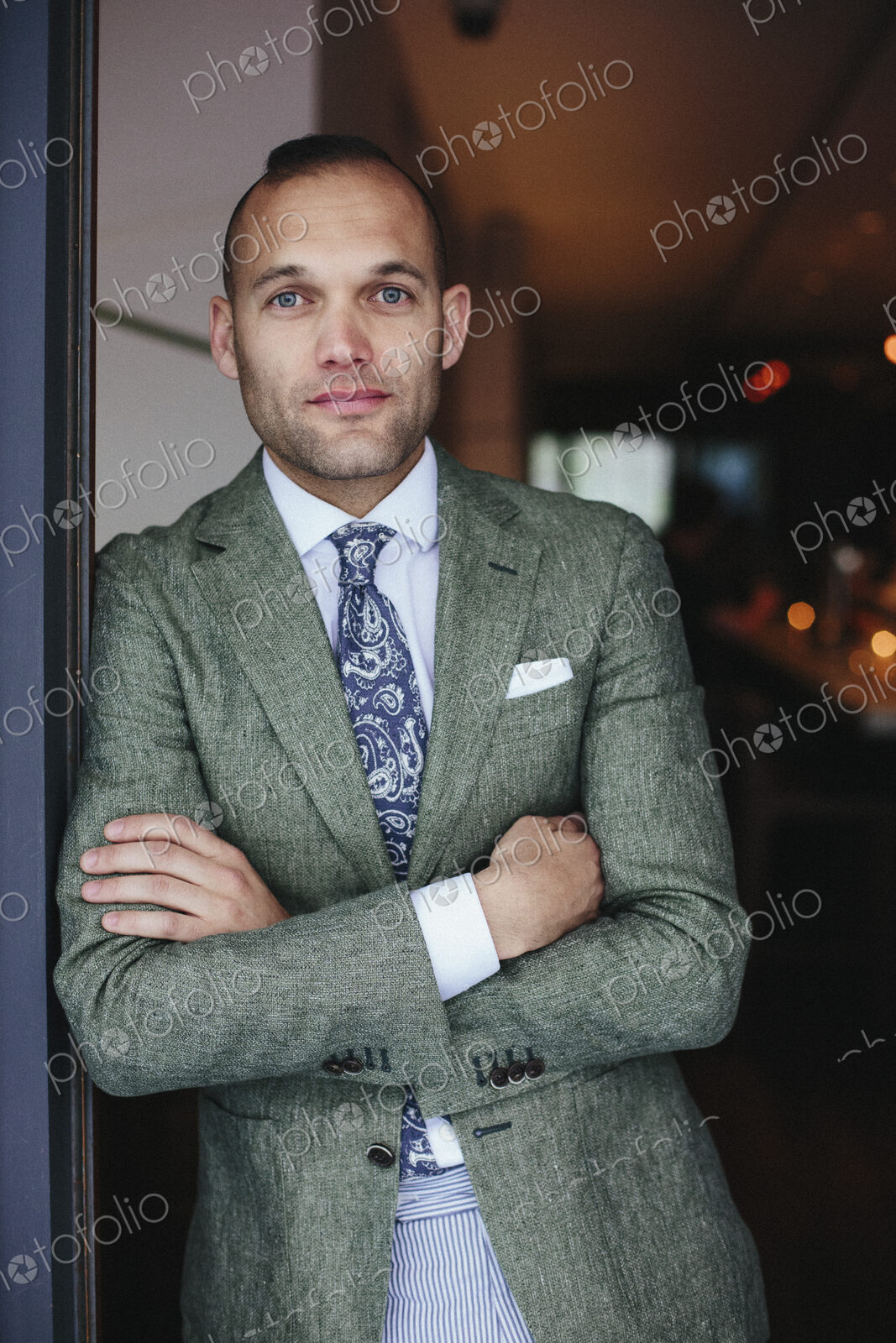 Portrait of the chef sommelier standing at the door of a city restaurant.