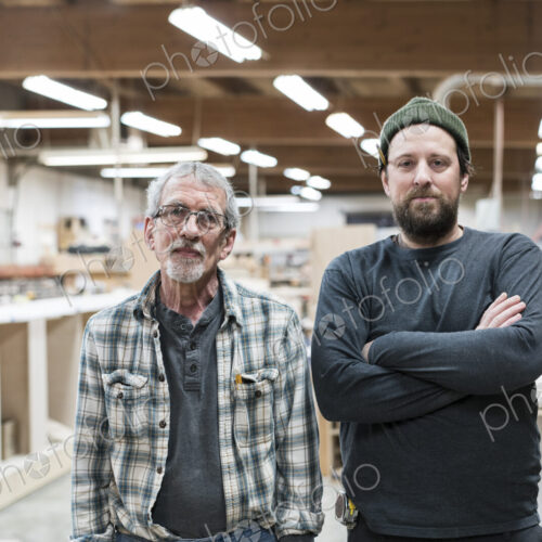 Portrait of two Caucasian carpenters in a large woodworking factory. Portrait of two Caucasian carpenters in a large woodworking factory.