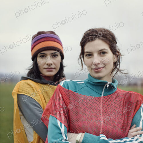 Portrait of two Caucasian women in sports clothing with team bibs of opposing teams… Portrait of two Caucasian women in sports clothing with team bibs of opposing teams…