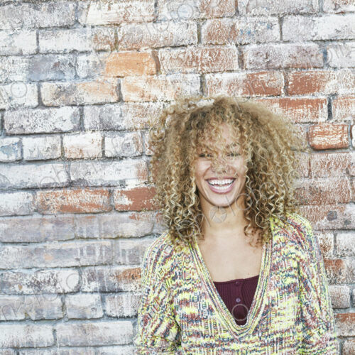 Portrait of young smiling woman with long curly blond hair, looking at camera. Portrait of young smiling woman with long curly blond hair, looking at camera.