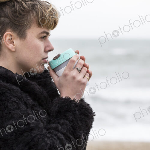 Portrait of young woman with brown hair and dreadlocks and a lip piercing wearing… Portrait of young woman with brown hair and dreadlocks and a lip piercing wearing…