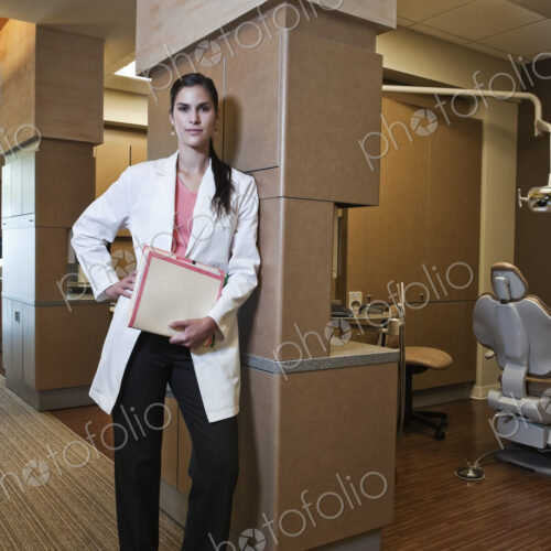 Portriat of an Hispanic dentist in her dental office. Portriat of an Hispanic dentist in her dental office.