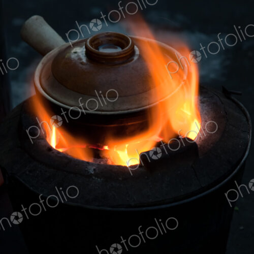 Pot simmering on a small barbeque, Yangon, Myanmar Pot simmering on a small barbeque, Yangon, Myanmar