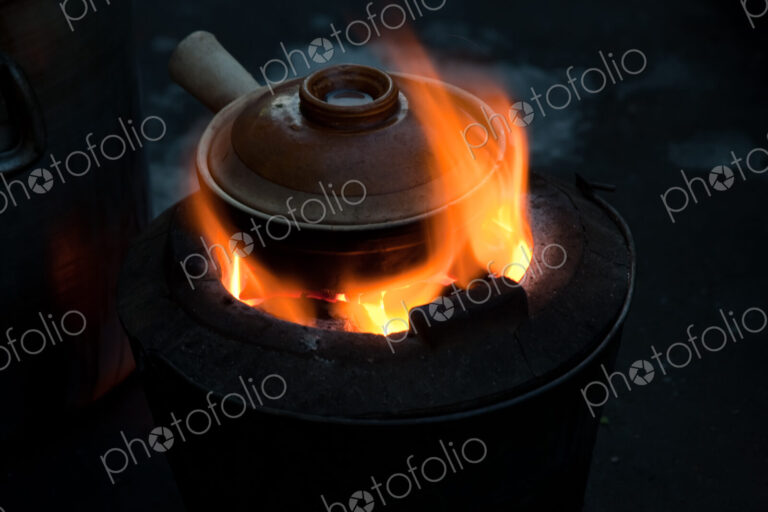 Pot simmering on a small barbeque, Yangon, Myanmar