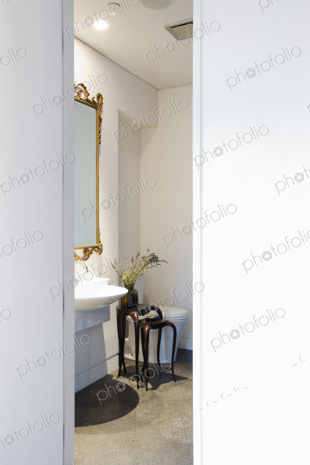 Powder room with toilet and hand basin and mirror.