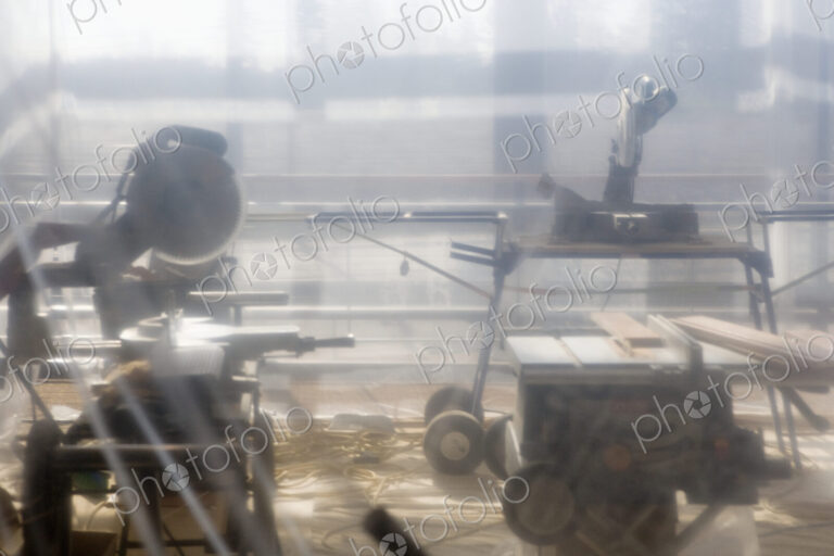 Power Tools Behind Plastic Sheet