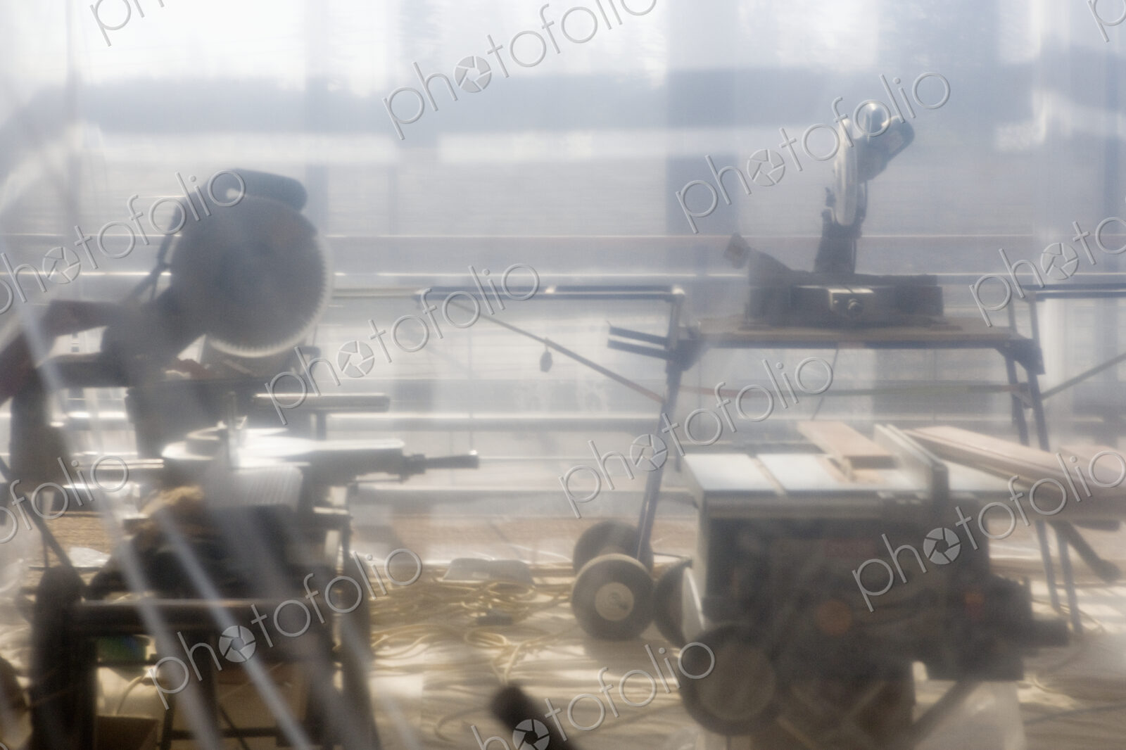 Power Tools Behind Plastic Sheet