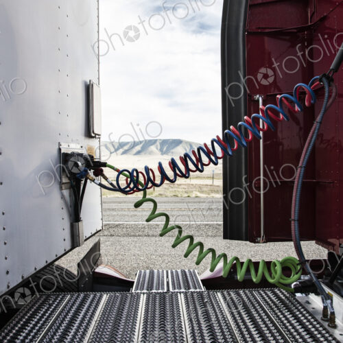 Power cables connecting the cab and the trailer of a class 8 commercial truck. Power cables connecting the cab and the trailer of a class 8 commercial truck.