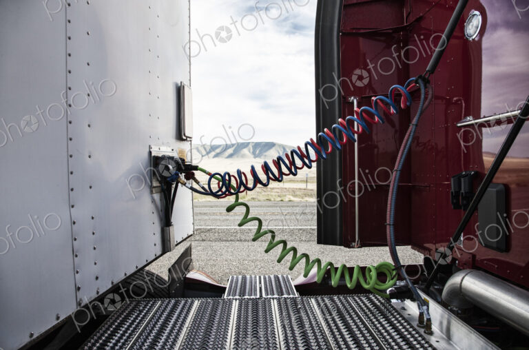 Power cables connecting the cab and the trailer of a class 8 commercial truck.