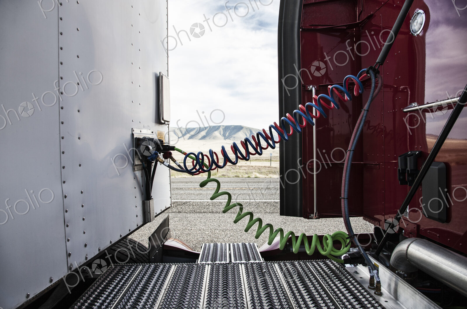 Power cables connecting the cab and the trailer of a class 8 commercial truck.