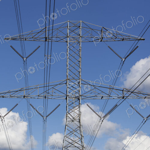 Power lines against blue sky