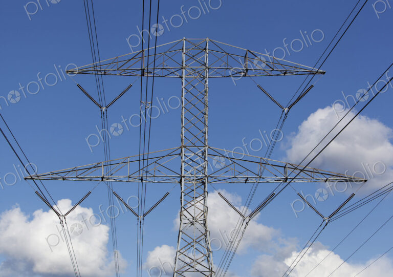 Power lines against blue sky