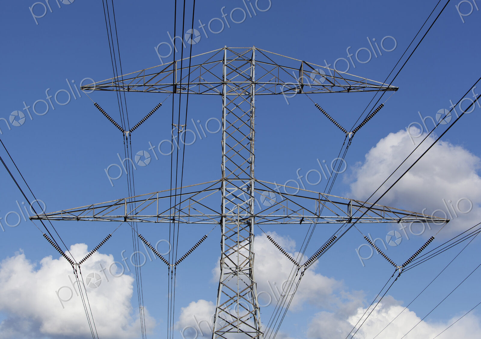 Power lines against blue sky