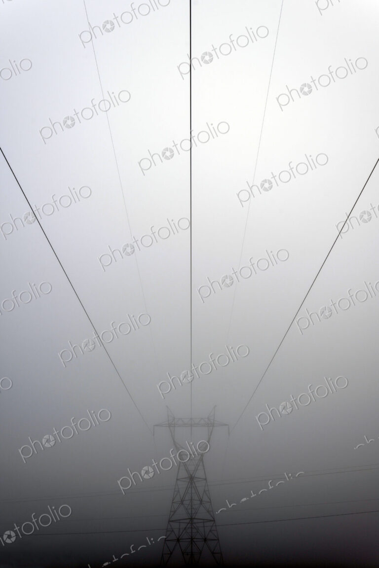 Power lines and foggy sky