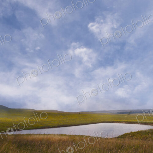 Prairie in summer, a lake and rolling landscape Prairie in summer, a lake and rolling landscape