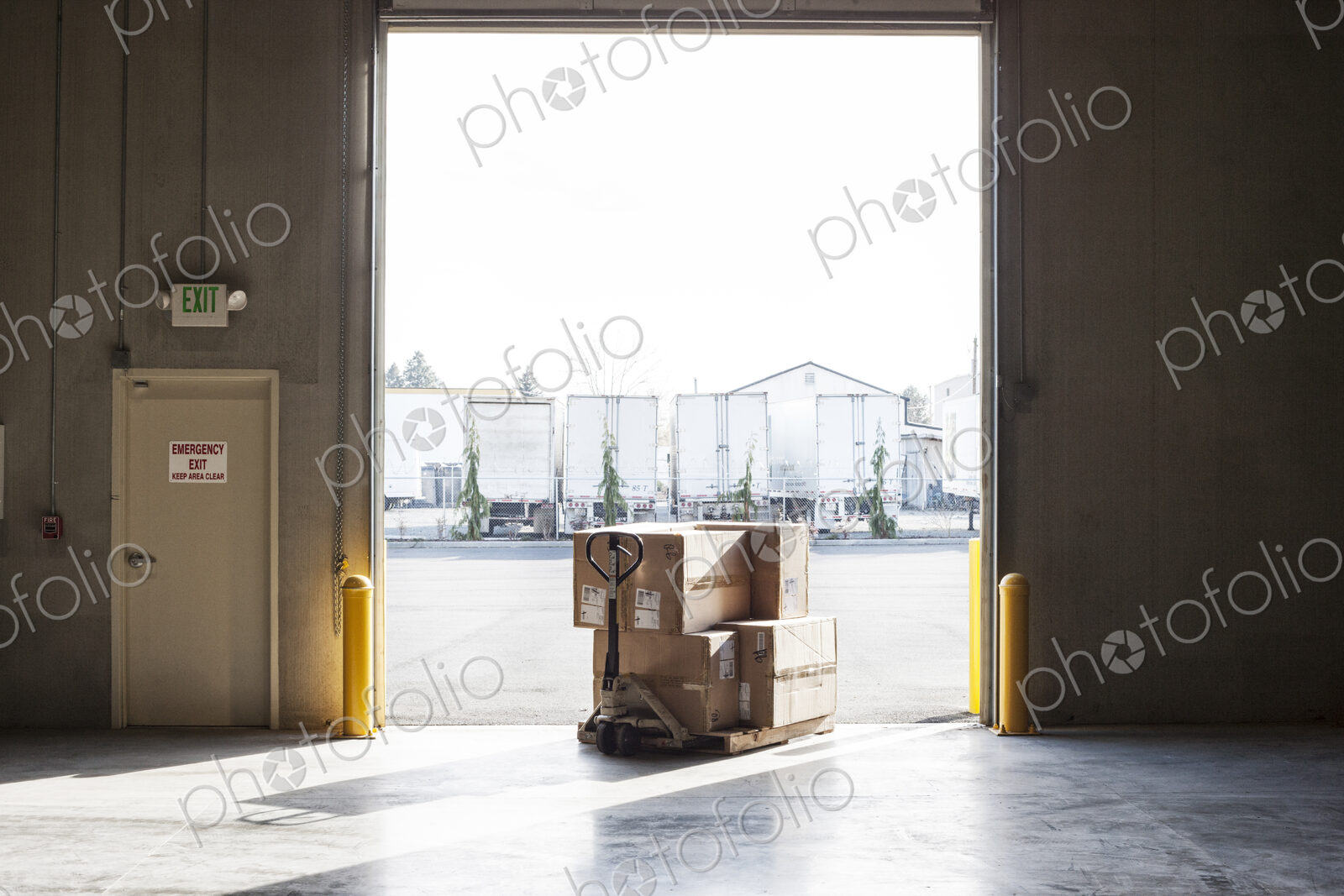 Products in boxes at a loading dock door in a distribution warehouse.