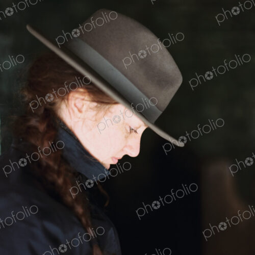 Profile of a woman wearing a felt hat with a brim. Profile of a woman wearing a felt hat with a brim.