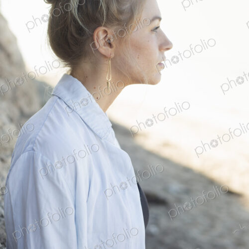 Profile portrait of a blond woman with a hair bun. Profile portrait of a blond woman with a hair bun.