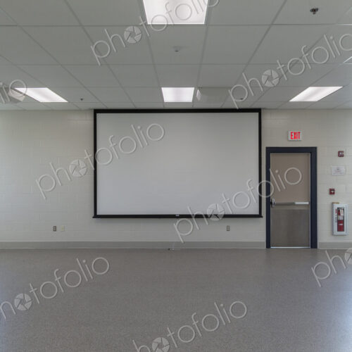 Projector screen in empty animal training room Projector screen in empty animal training room
