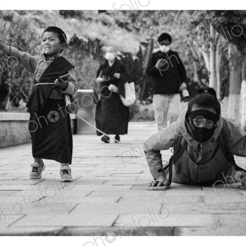 Prostrating Tibetan with her Son in-Tow Potala Palace, Lhasa, Autonomous Region of Tibet