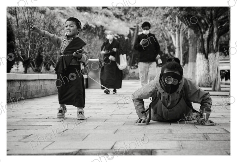 Prostrating Tibetan with her Son in-Tow Potala Palace, Lhasa, Autonomous Region of Tibet