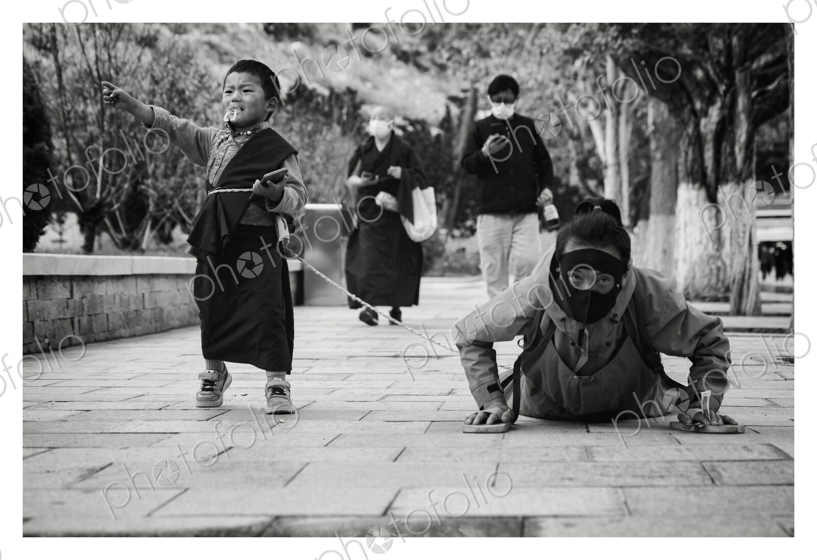 Prostrating Tibetan with her Son in-Tow Potala Palace, Lhasa, Autonomous Region of Tibet