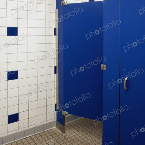 Public bathroom showers and toilet cubicles with blue doors. Public bathroom showers and toilet cubicles with blue doors.