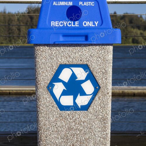 Public recycling bin with blue lid labeled for aluminum and plastic, featuring the…