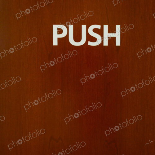 Push sign on wooden door, USA
