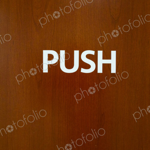Push sign on wooden door, USA