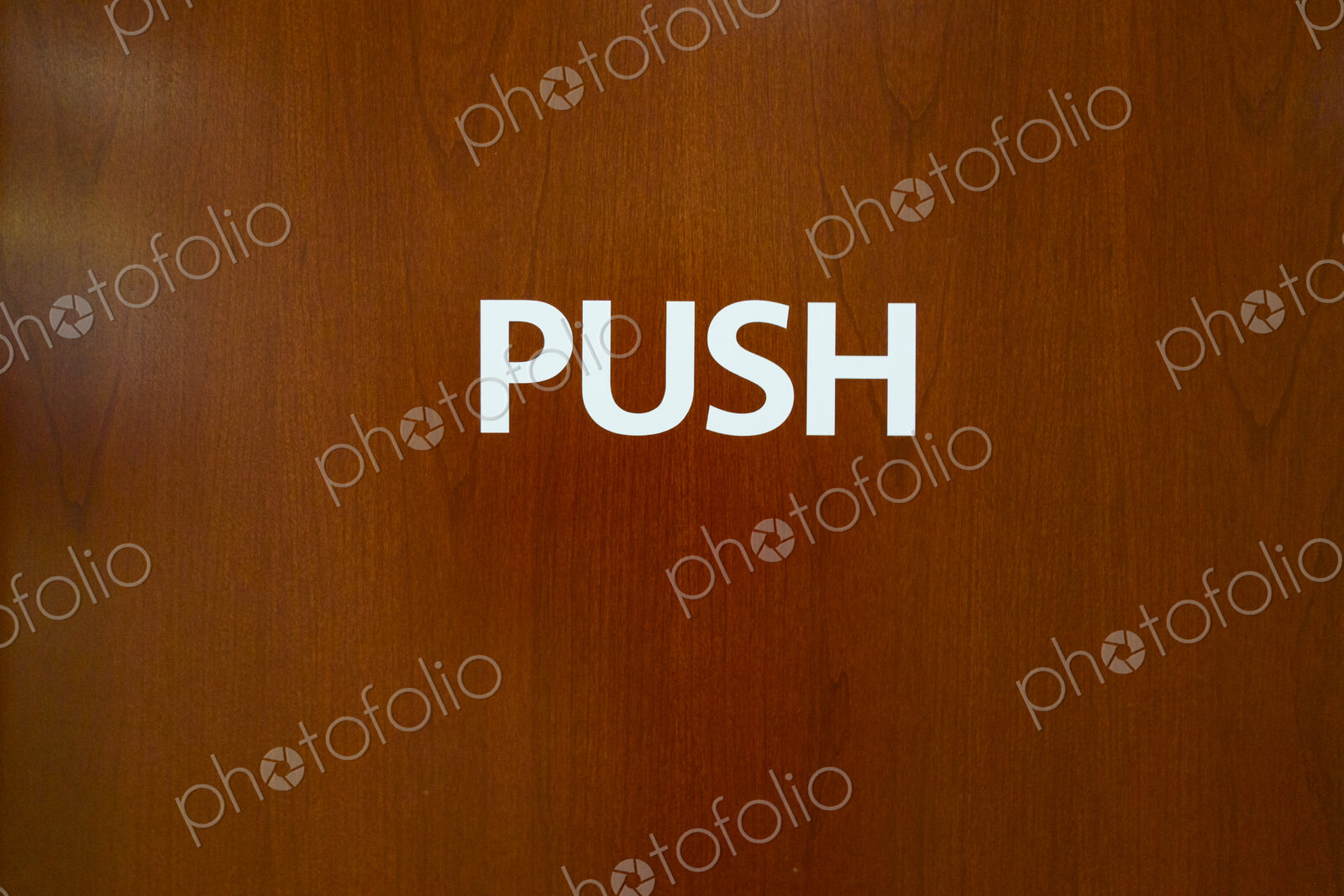 Push sign on wooden door, USA