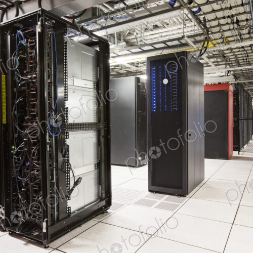 Racks of servers aligned in rows in a large computer server farm. Racks of servers aligned in rows in a large computer server farm.