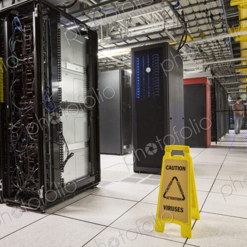 Racks of servers aligned in rows in a large computer server farm. Racks of servers aligned in rows in a large computer server farm.