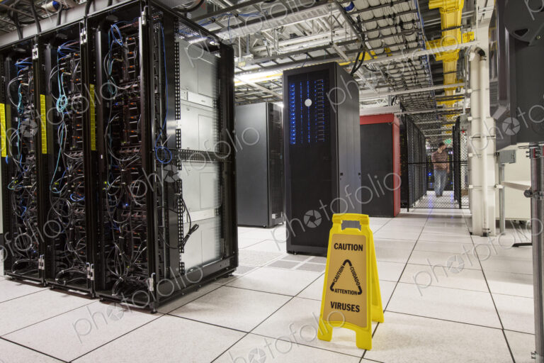 Racks of servers aligned in rows in a large computer server farm.