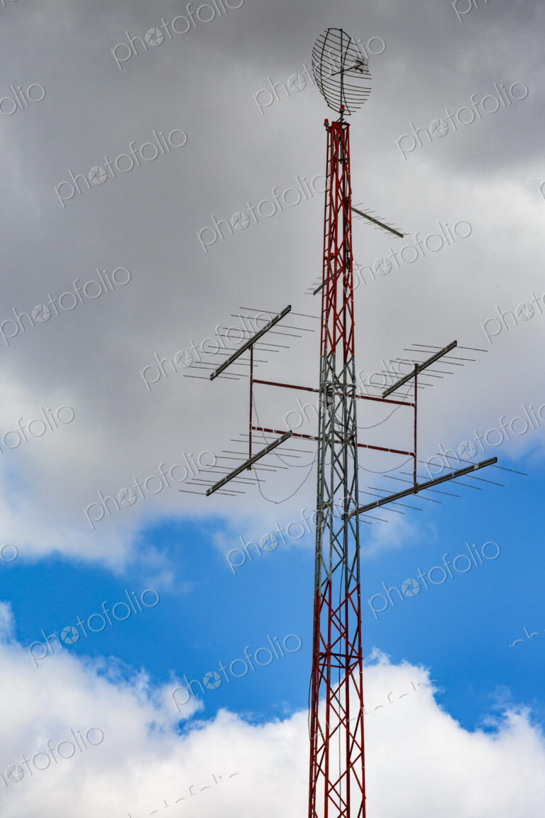 Radio antennae a central metal pole and aerials with a shaped metal skeleton dish at…