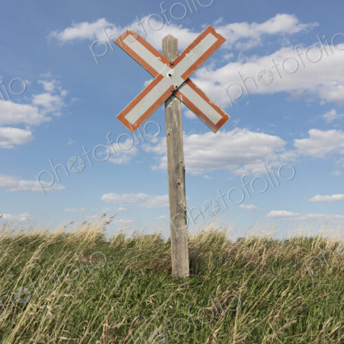 Railroad caution sign on prairie, near Swift Current, Saskatchewan, Canada. Railroad caution sign on prairie, near Swift Current, Saskatchewan, Canada.