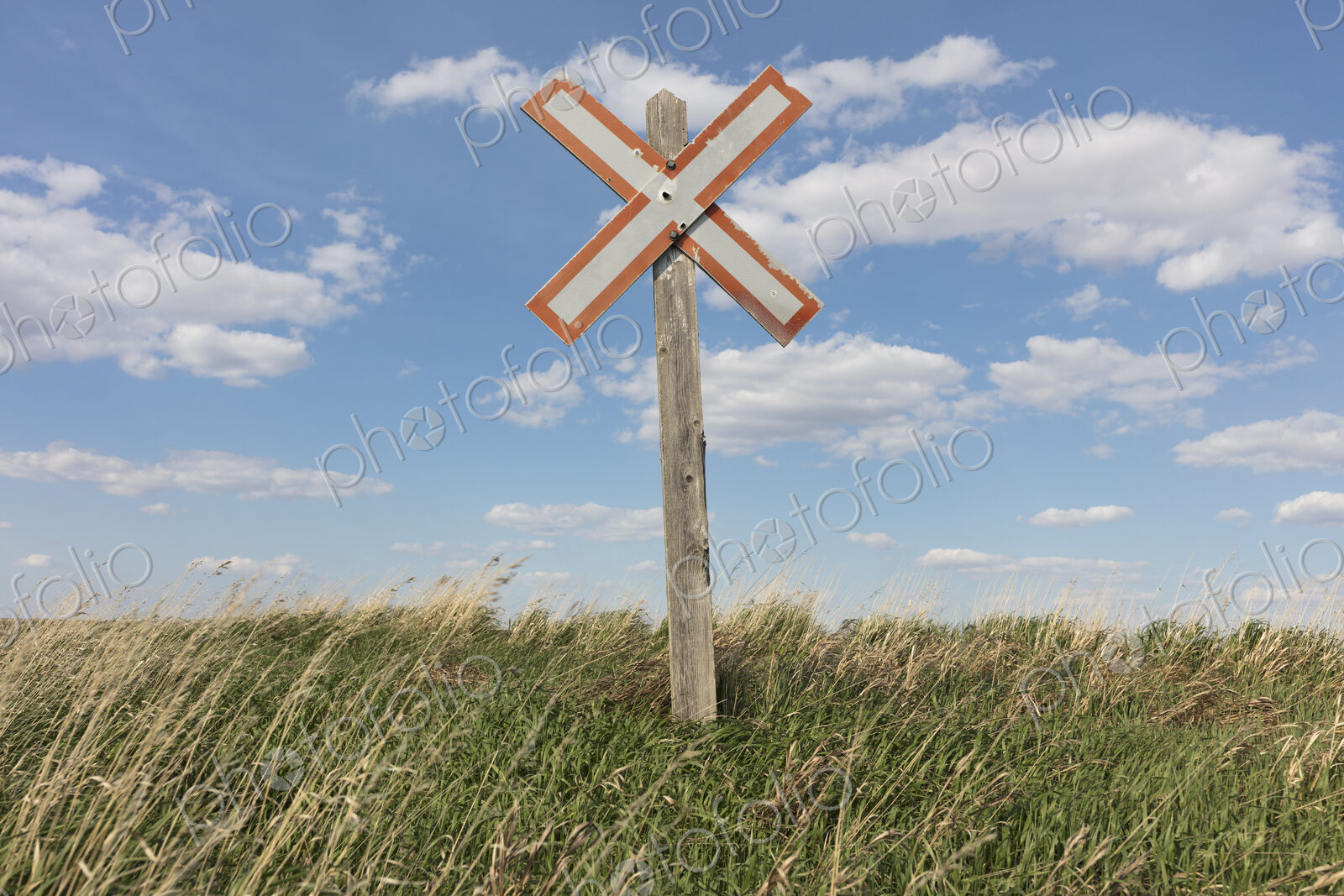 Railroad caution sign on prairie, near Swift Current, Saskatchewan, Canada.