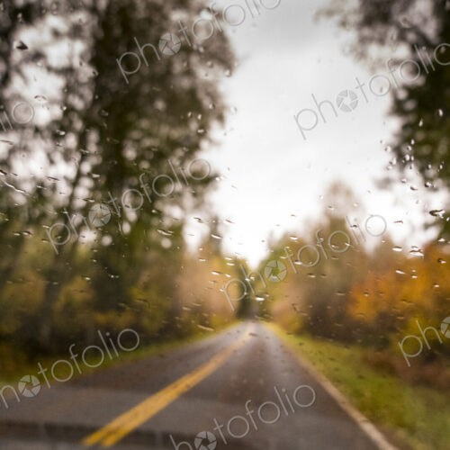 Rain drops on the windshield of a car.