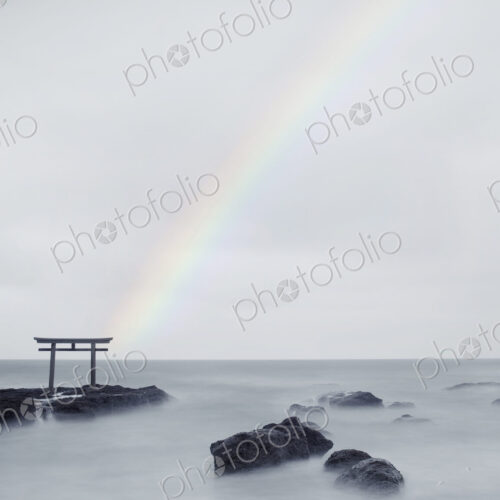 Rainbow over tall Torii gate on rocks in the middle of a lake. Rainbow over tall Torii gate on rocks in the middle of a lake.