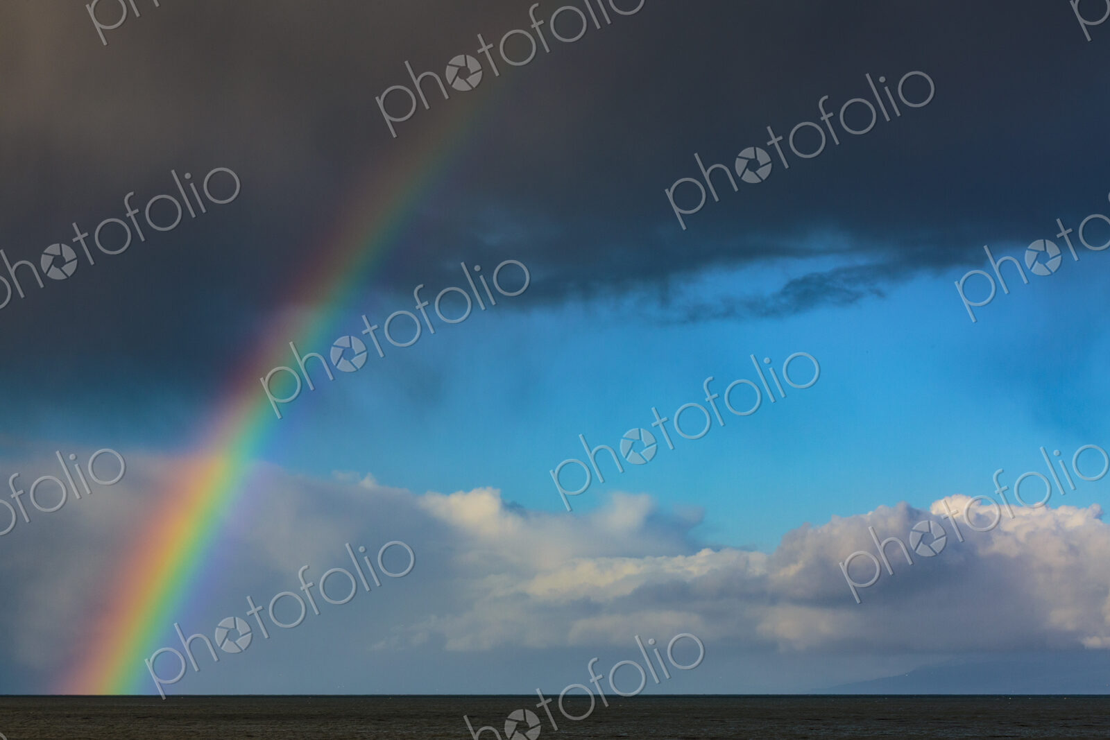 Rainbow over water with dark storm clouds on the Strait of Juan de Fuca, Port Angeles