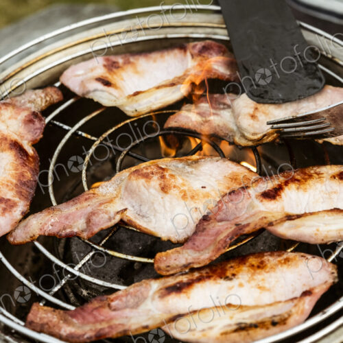 Rashers of bacon on a grill, breakfast.
