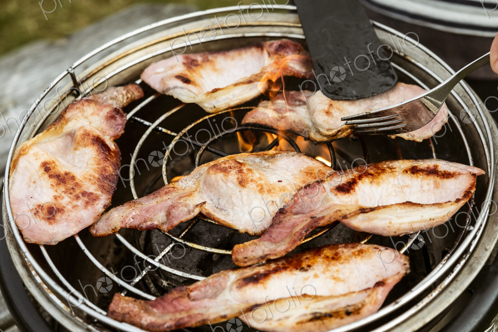 Rashers of bacon on a grill, breakfast.