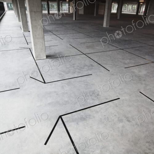 Raw office space with new offices outlined in tape.