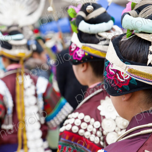 Rear view of girls wearing colourful traditional Chinese costumes and headdresses…