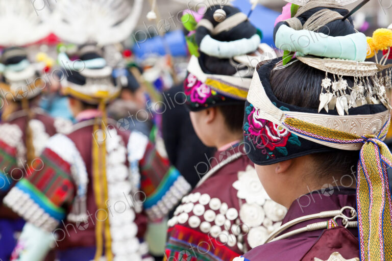Rear view of girls wearing colourful traditional Chinese costumes and headdresses…