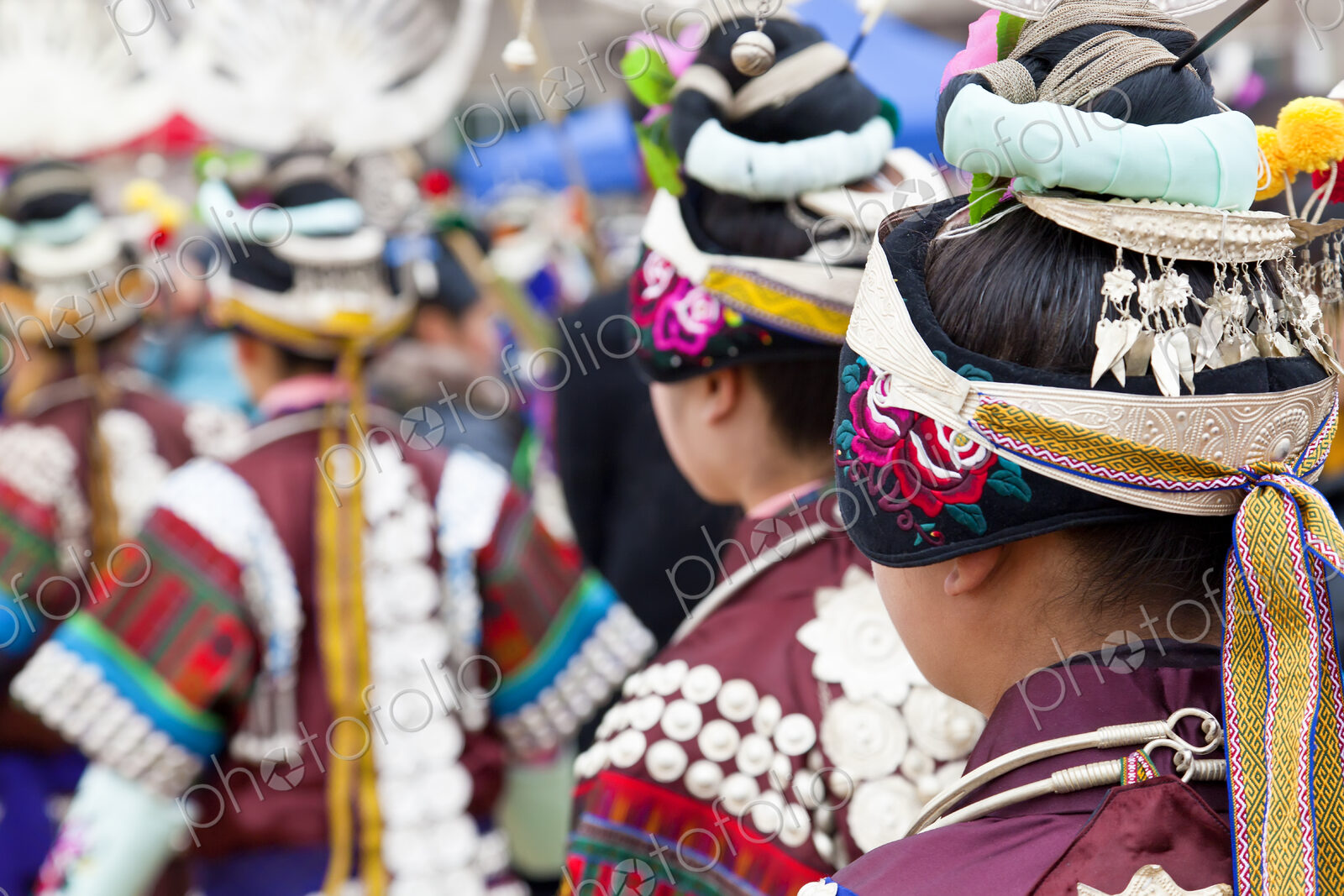 Rear view of girls wearing colourful traditional Chinese costumes and headdresses…