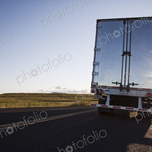 Rear view of the trailer on a Class 8 commercial truck on the highway.